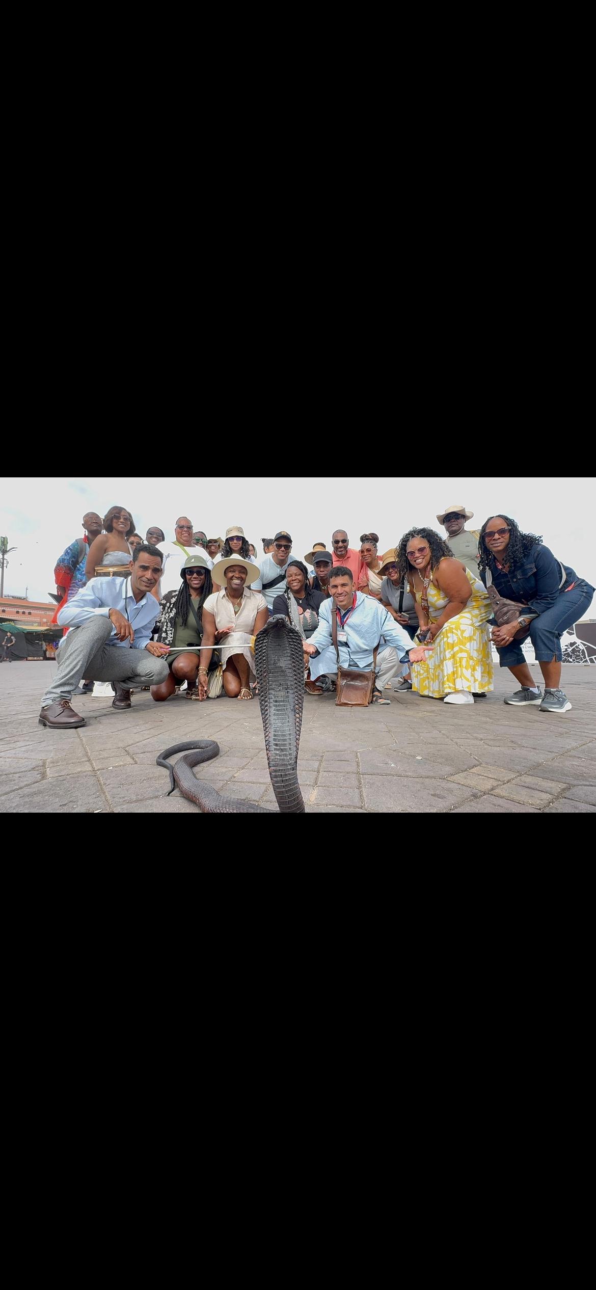 Large tour group with snake charmer at Jemaa el-Fnaa square
